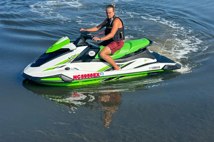a man riding a wave on a surf board on a body of water