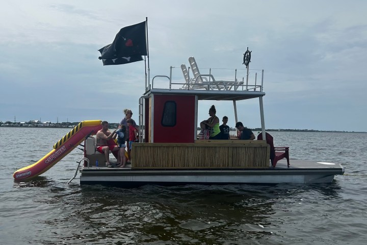 a group of people in a boat on a body of water